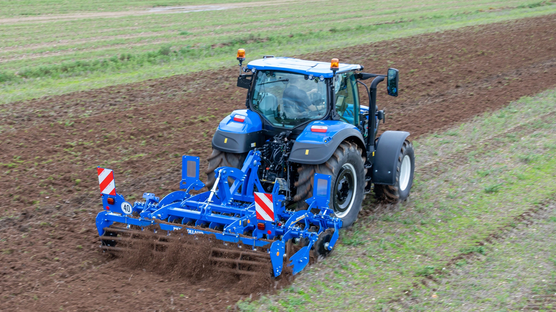 Soil preparation with SDM & SDH Compact Disc Cultivators attached to a New Holland tractor on farmland