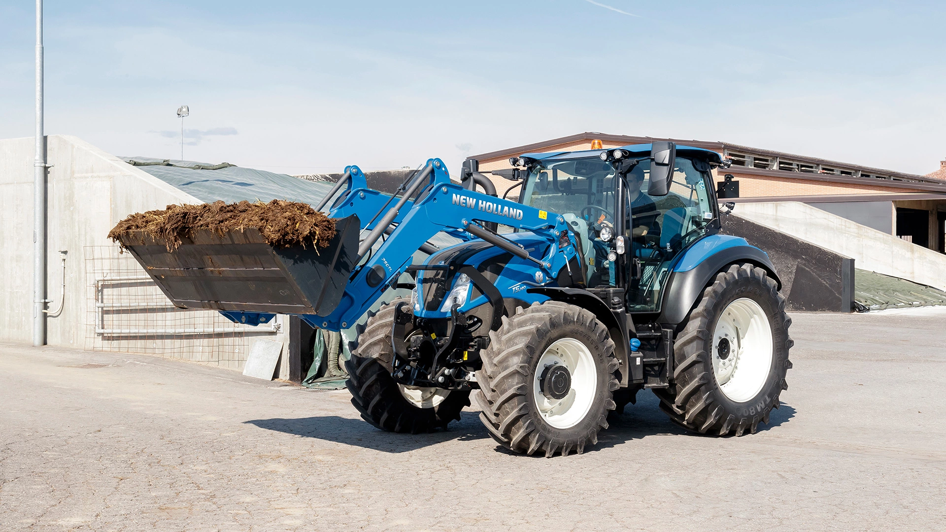 New Holland T5 Dynamic Command & Auto Command farming tractor with a front loader