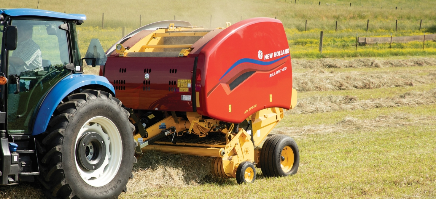 Roll-Belt™ Round Baler picks up hay in the field