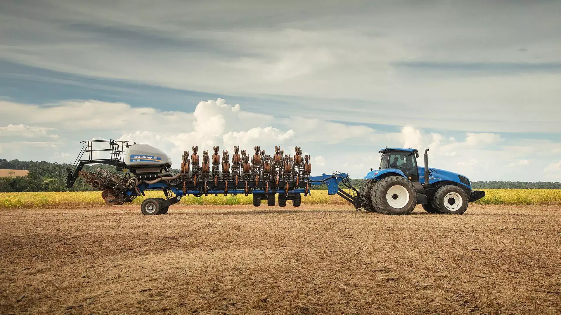 plantadeiras new holland modelo  pl7000 em campo visão lateral com linhas recolhidas