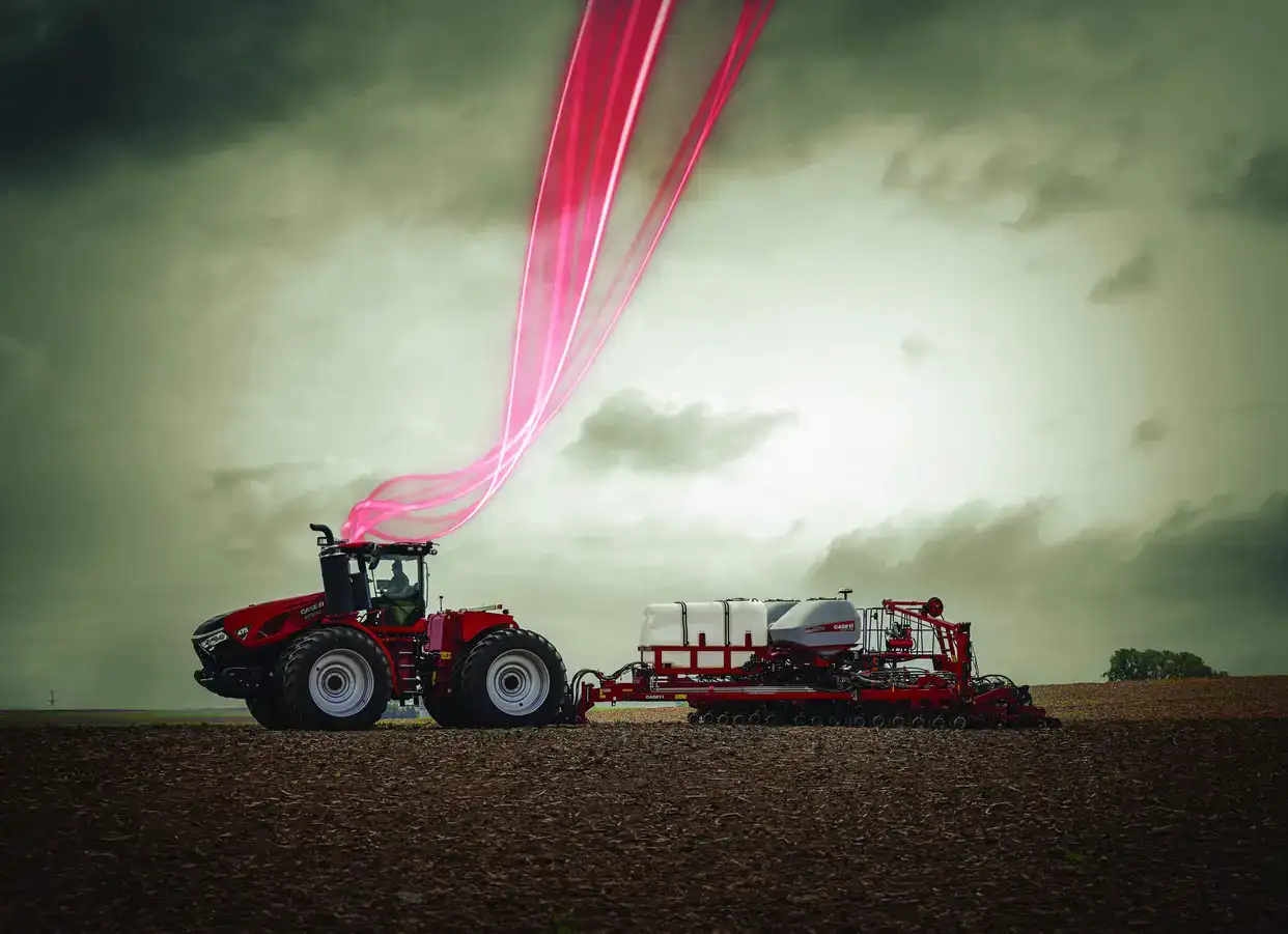 A Case IH tractor with a futuristic design plows a field under a stormy sky. Pink light trails extend from its cab, adding a dynamic and innovative tone.