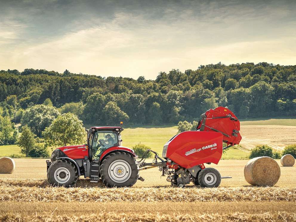 Red Case IH tractor with baler attachment in field