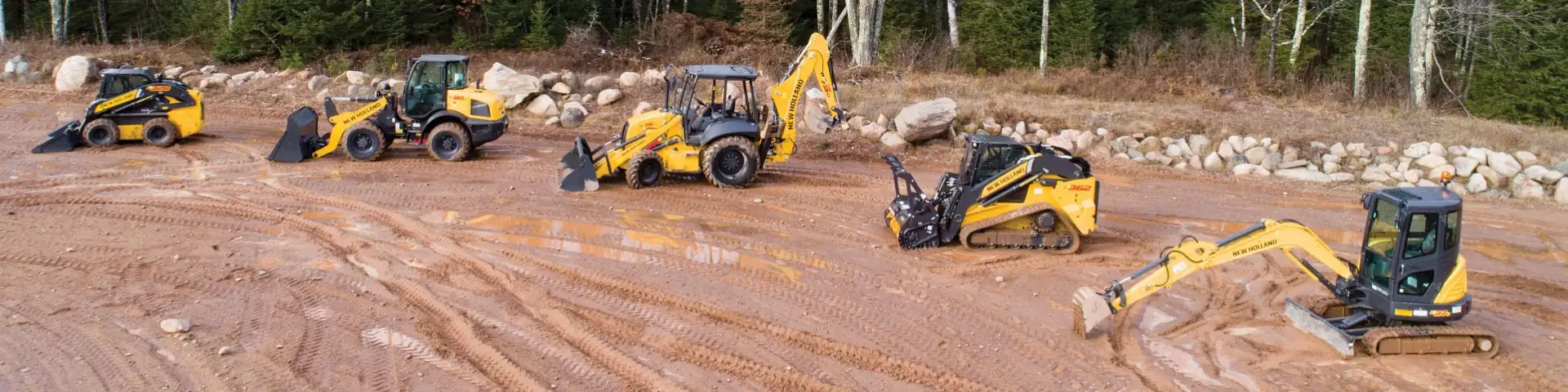 New Holland construction equipment lined up on a jobsite