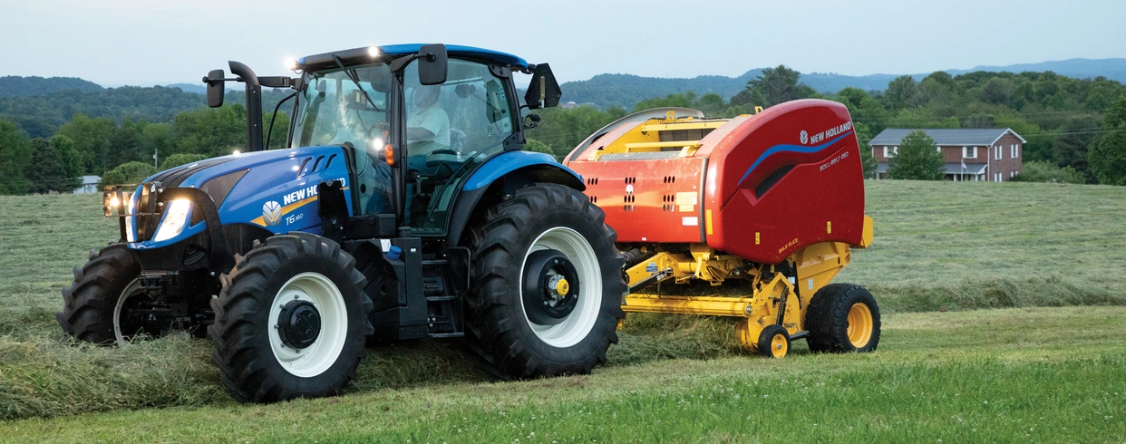 T6 tractor pulling a baler