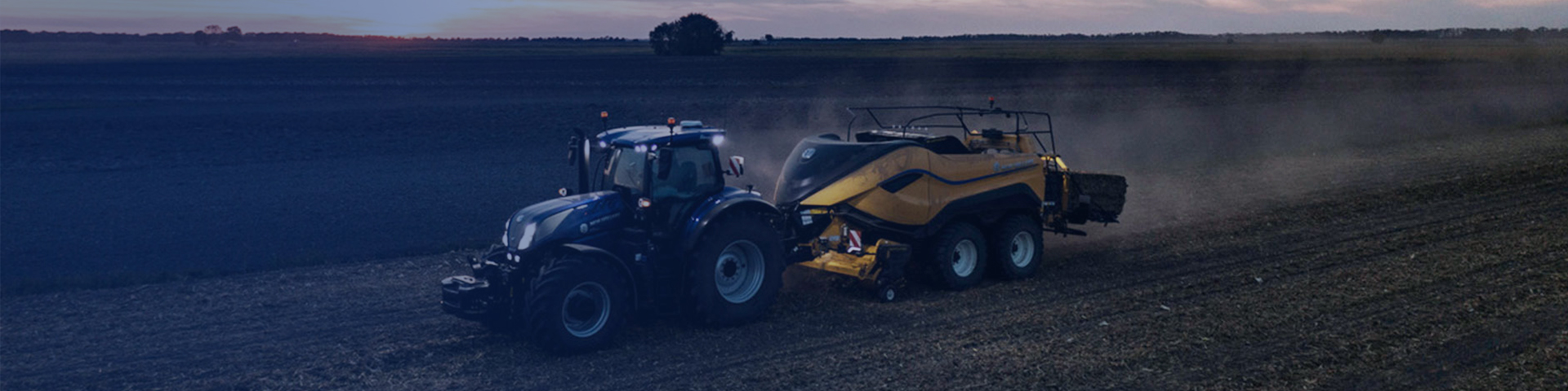New Holland tractor working in field in background