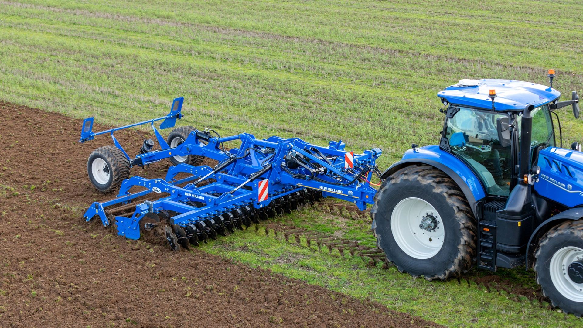 Soil preparation with SDM & SDH Compact Disc Cultivators attached to a New Holland tractor on farmland